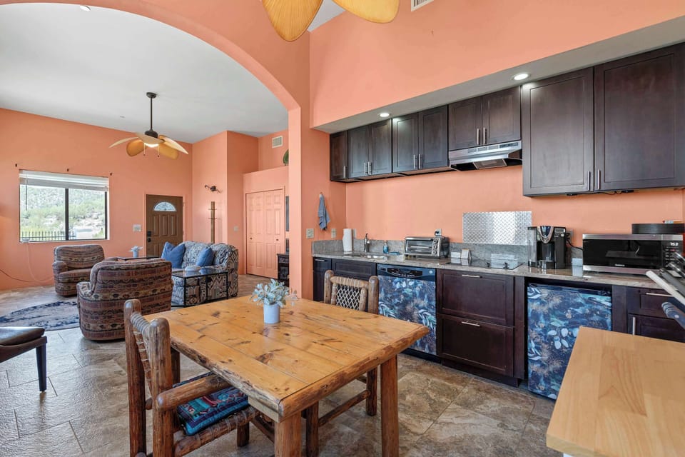 Enjoy the vibrant heart of the home with a fully equipped kitchen, rustic dining table, and open layout that flows seamlessly into the cozy living space.