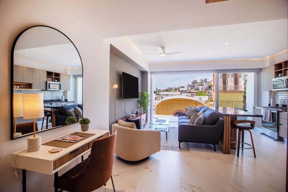Stylish living area—comfortable sofa, smart TV, dedicated workspace and private balcony