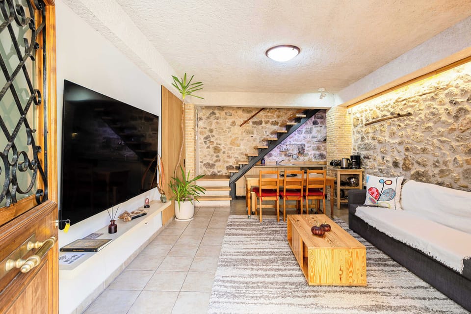 Cozy Living Room with Rustic Stone Walls and Wooden Accents