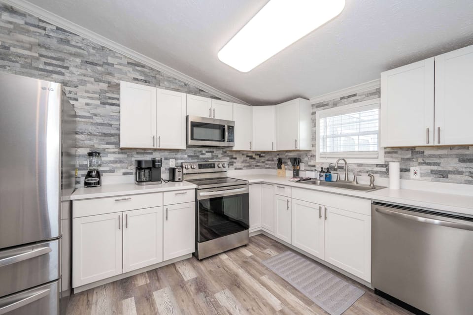 The open, airy kitchen offers ample space & every home comfort