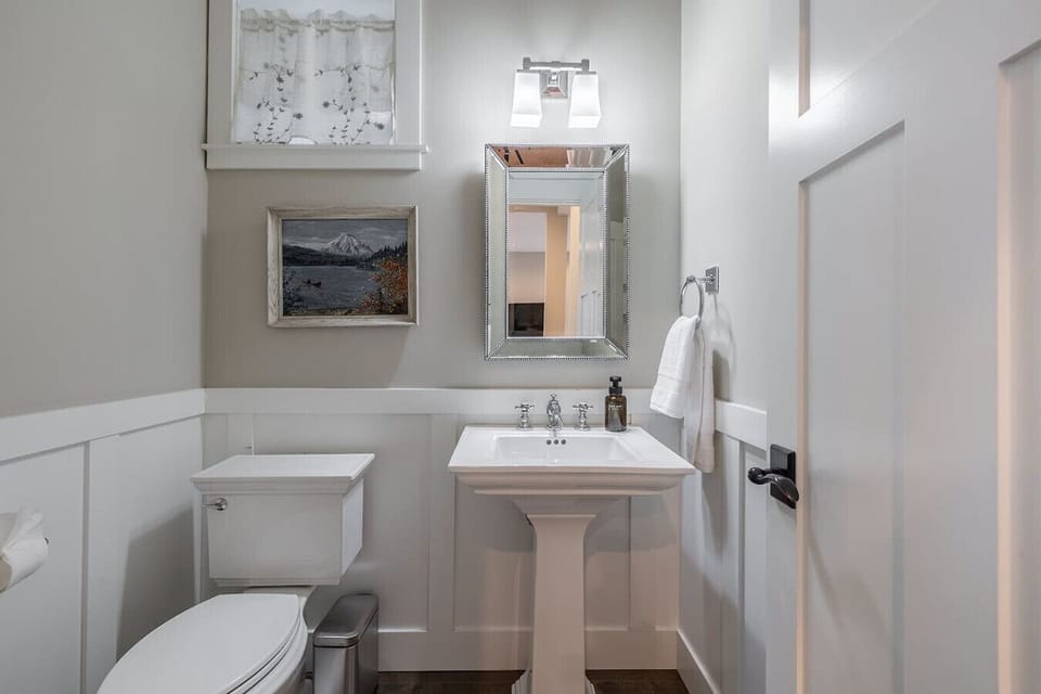 Charming Half Bathroom: Conveniently located and beautifully designed for quick refreshes.