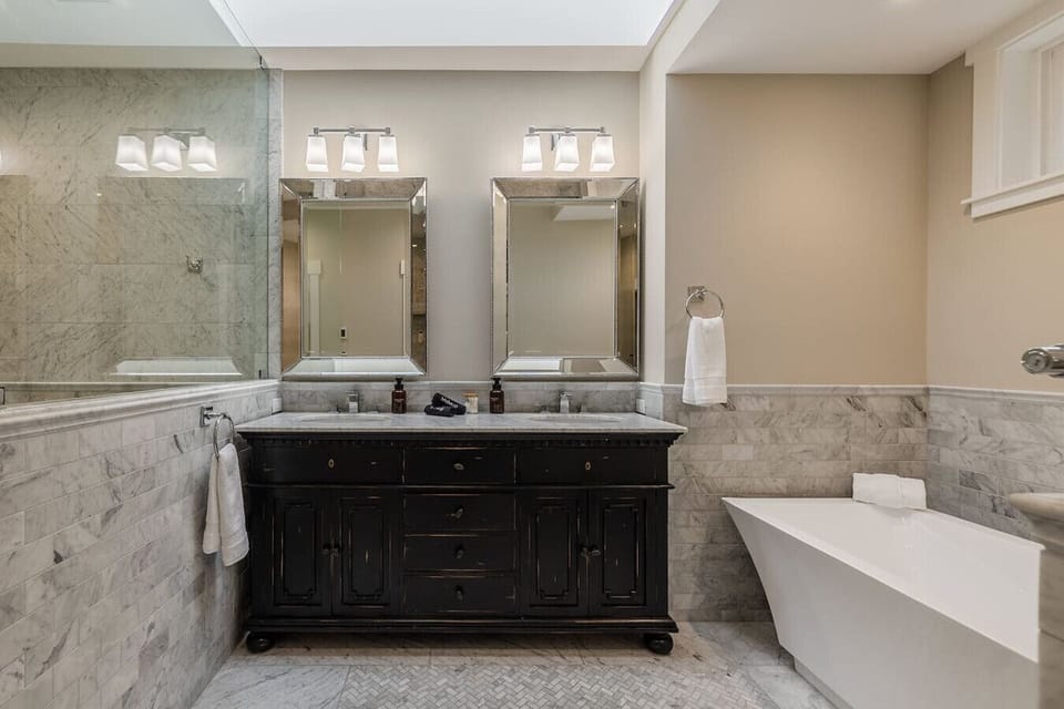 Enjoy a luxurious bath or shower in a bathroom that blends comfort with elegance.