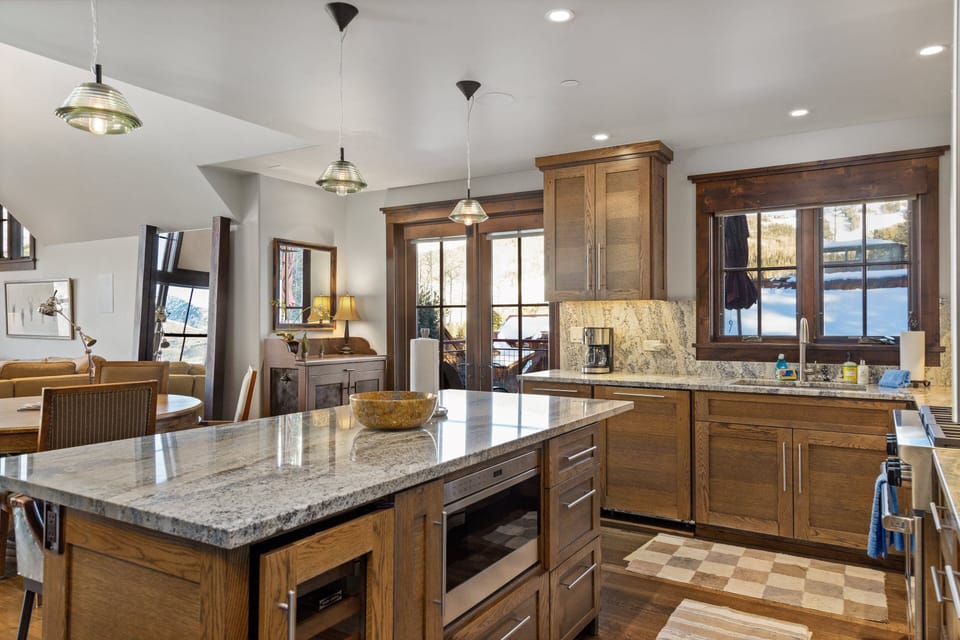 Large kitchen island with seating for 3 opens up towards living room