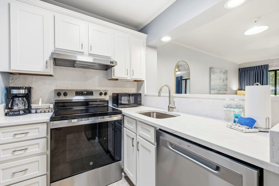 Updated kitchen with quartz countertops and stainless appliances. 