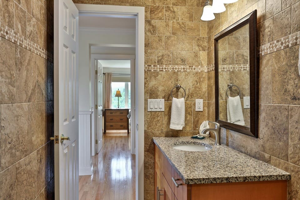 There is counter space beside the sink for getting ready, with the hallway just outside.