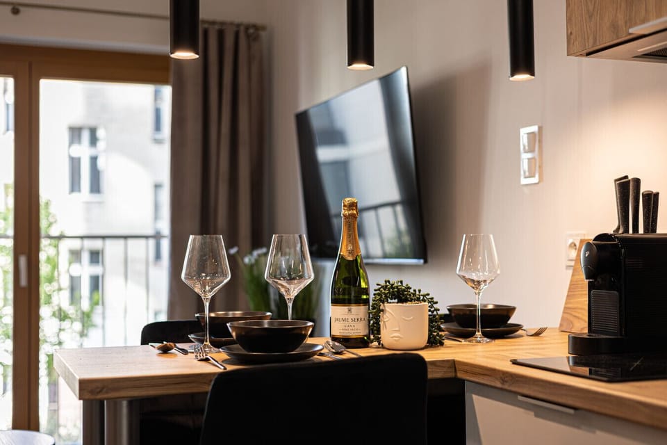 Elegantly set table with wine glasses, perfect for a romantic dinner in an apartment near Bydgoszcz city center and Opera Nova.
