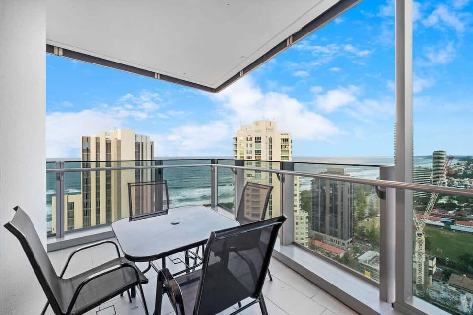 Balcony with outdoor seating—perfect spot for your morning coffee or a sunset wine. Enjoy sweeping 180° views of the ocean and skyline.