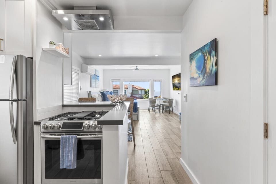 Sleek, fully equipped kitchen leading to the open-concept living space.