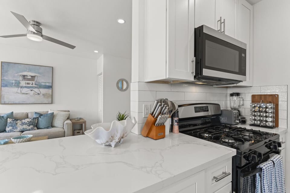 Stylish kitchen with a gas stove and elegant marble countertops.