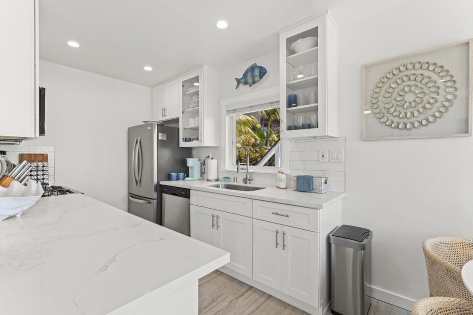 Sleek kitchen with modern appliances and a coastal touch.