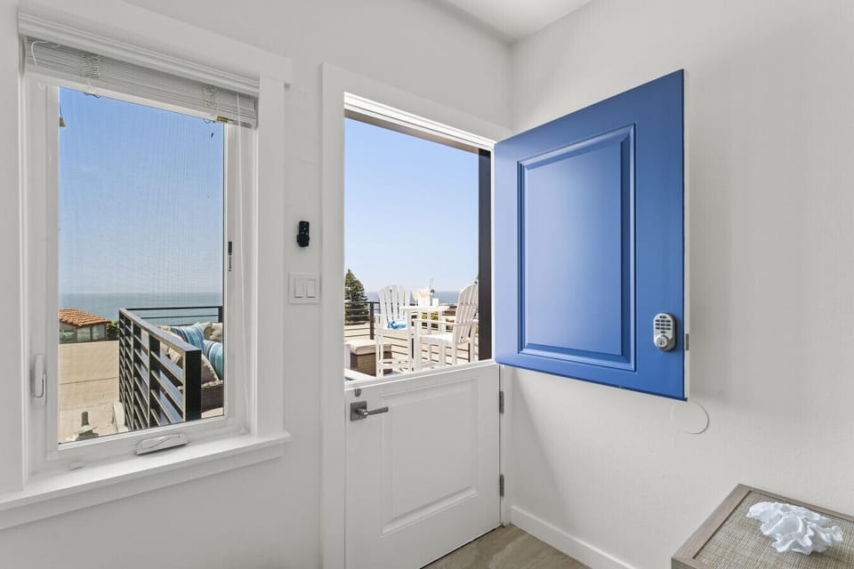 Bright entryway with a welcoming pop of blue and direct ocean view.