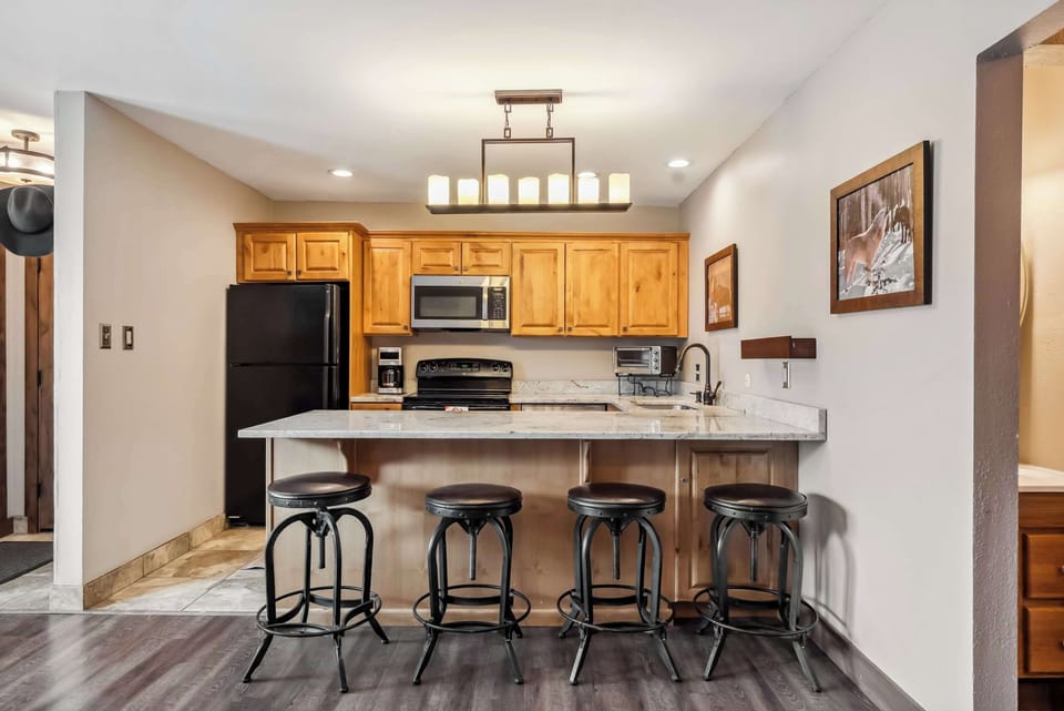 Kitchen: Drip coffee maker, Crockpot, blender, toaster, kettle, cooking utensils, tableware