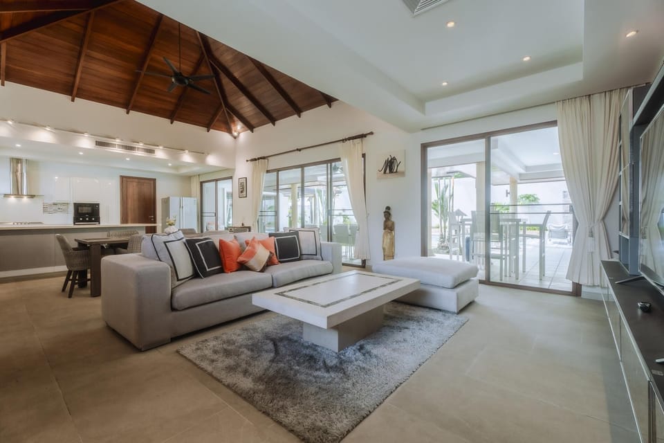 Open-plan living room with modern kitchen and elegant dining area.