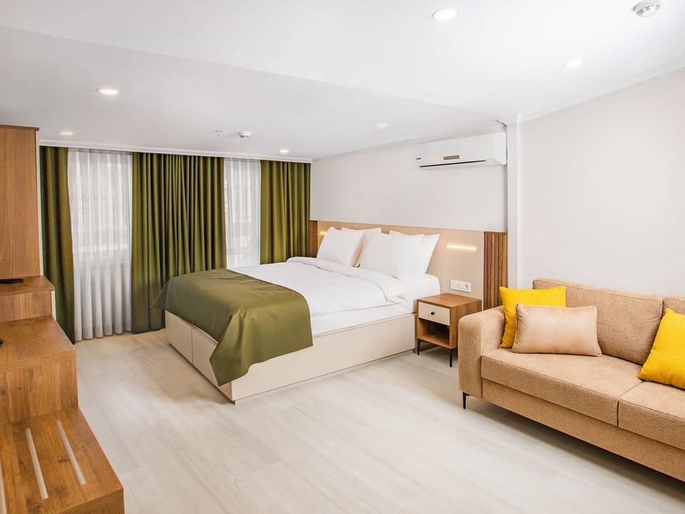 Family Quadruple Room, Balcony, City View | Minibar, in-room safe, soundproofing, iron/ironing board