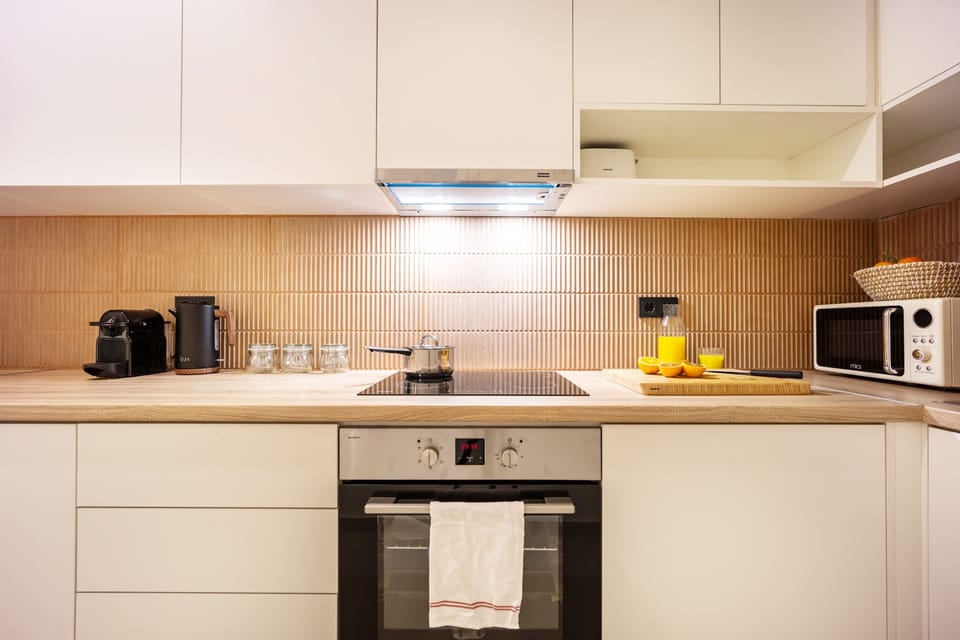 Fully equipped modern kitchen with sleek finishes for effortless cooking during comfortable extended stays.