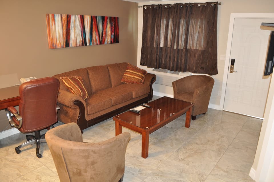 Suite, Lake View | Living area | Flat-screen TV