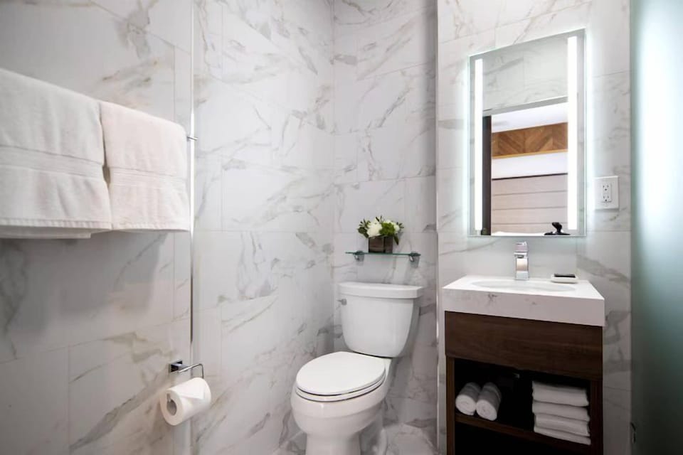 Shower, hair dryer, slippers, towels