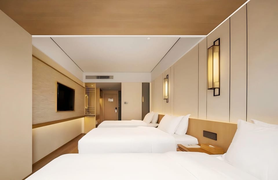Exclusive Triple Room, City View | Desk, laptop workspace, blackout drapes, soundproofing