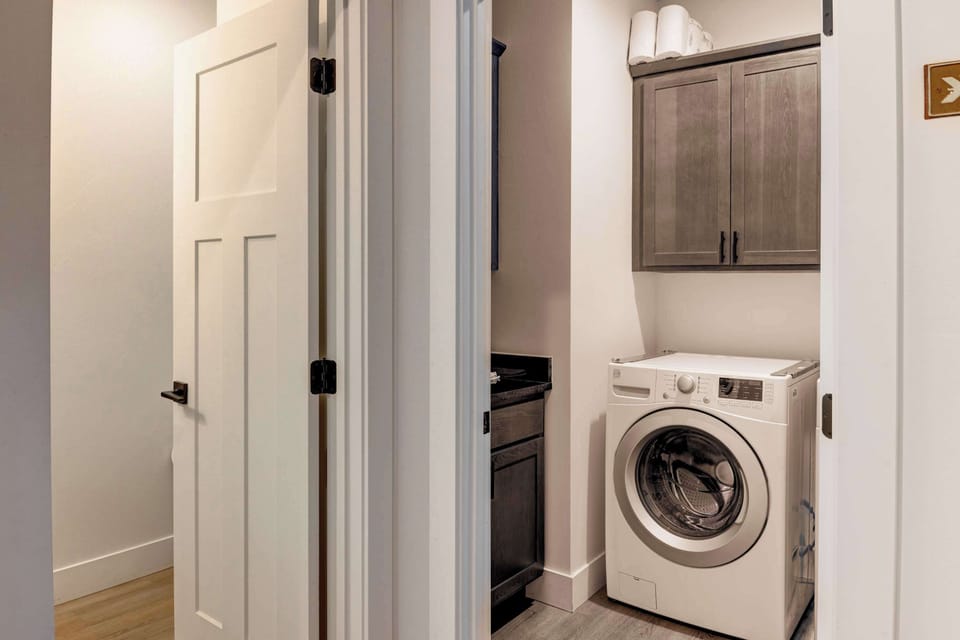 Laundry Room: Convenient laundry room equipped with modern washer and dry