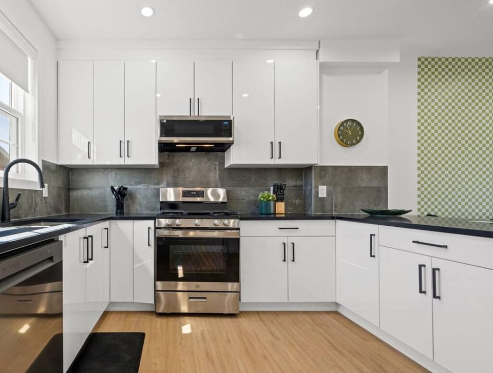Perfect meals start here! Modern kitchen with fridge, oven, microwave, & dishwasher.