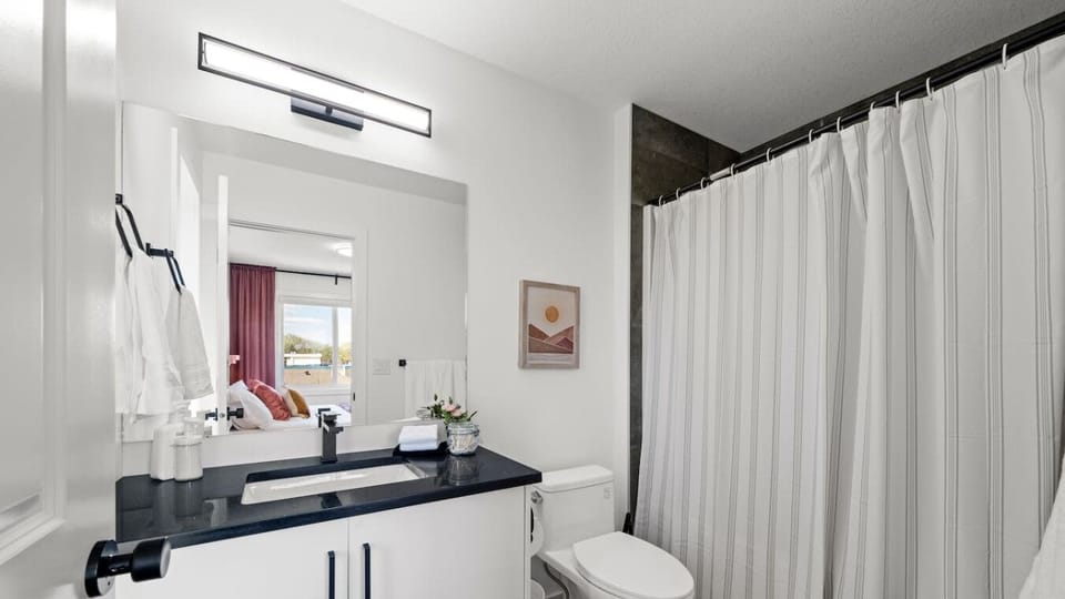 Sparkling clean bathroom with complete toiletries provided.