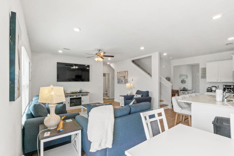 Your spacious open living area flows seamlessly from cozy seating to modern kitchen, creating the perfect gathering space for memorable moments.