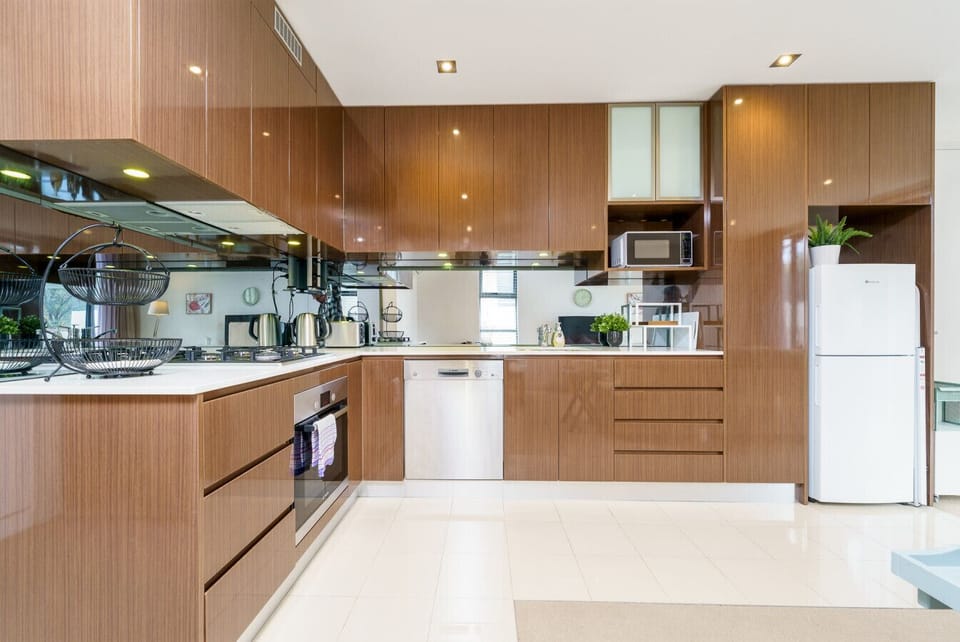 A stylish, functional kitchen showcasing contemporary cabinetry, a microwave, and a bright, open feel.