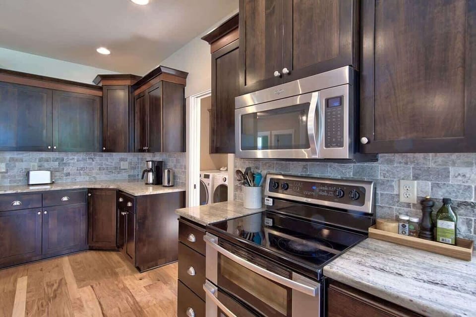 Prepare meals with ease using stainless steel appliances, ample cabinetry, and expansive counter space.