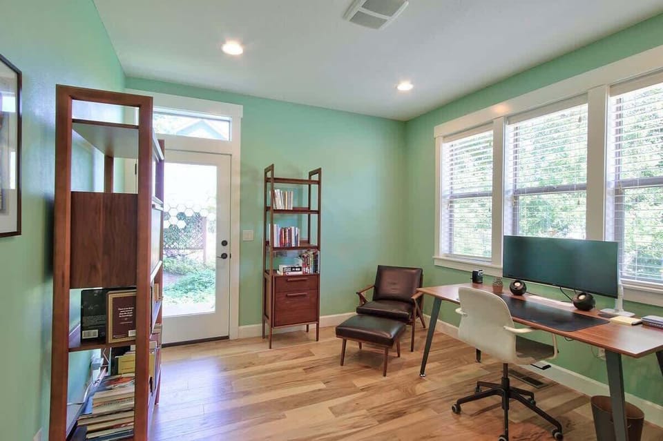 This versatile room serves as both a productive workspace and cozy reading retreat.