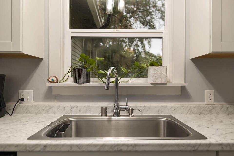 Kitchen window overlooking the peaceful backyard