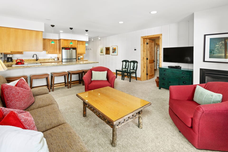 Open living space featuring a comfortable seating area and gourmet kitchen. Dining for 6 at the granite counter.