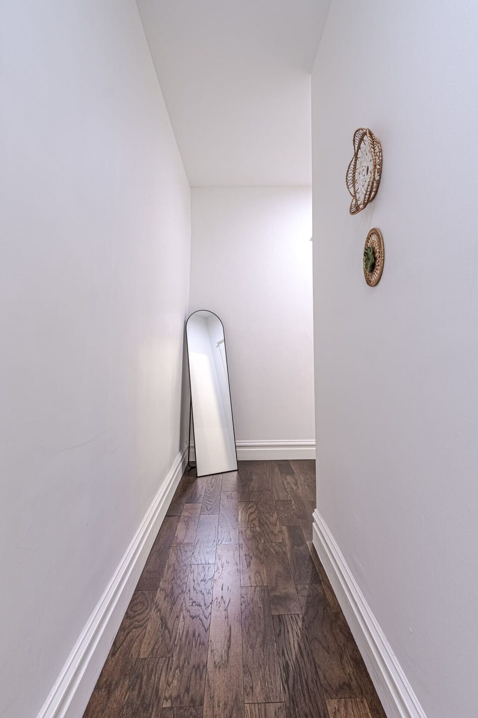 Walk through this spacious hallway and take advantage of the full-length mirror, designed to enhance the room’s openness while offering a practical space for your daily preparations.