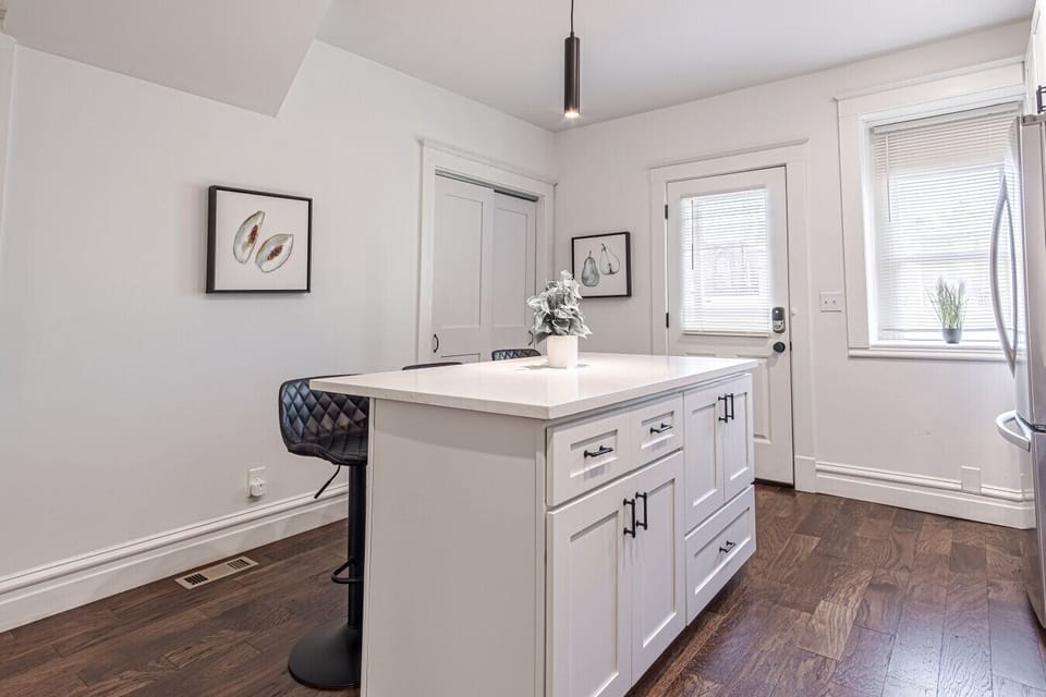 With three comfortable seats at the kitchen island, this space is perfect for casual meals, working, or socializing. The island`s functionality provides ample space for food preparation and ensures a versatile, multitasking area