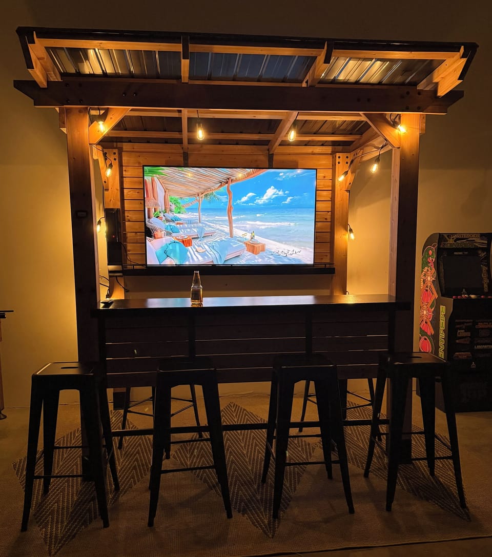 Cedar bar in garage with seating for 6 with flat screen smart tv.