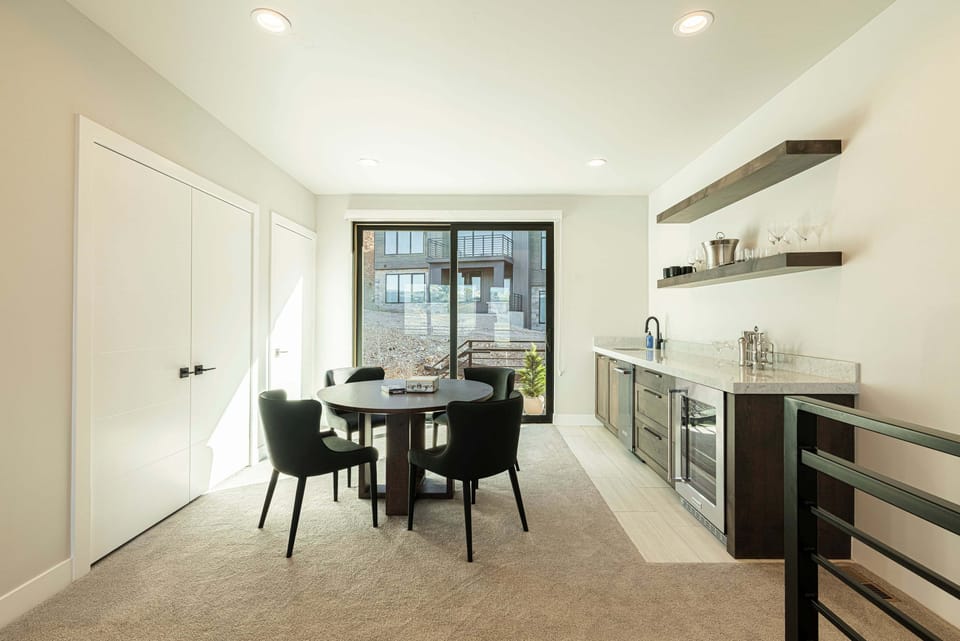 3rd level family room with a game table and  wet bar