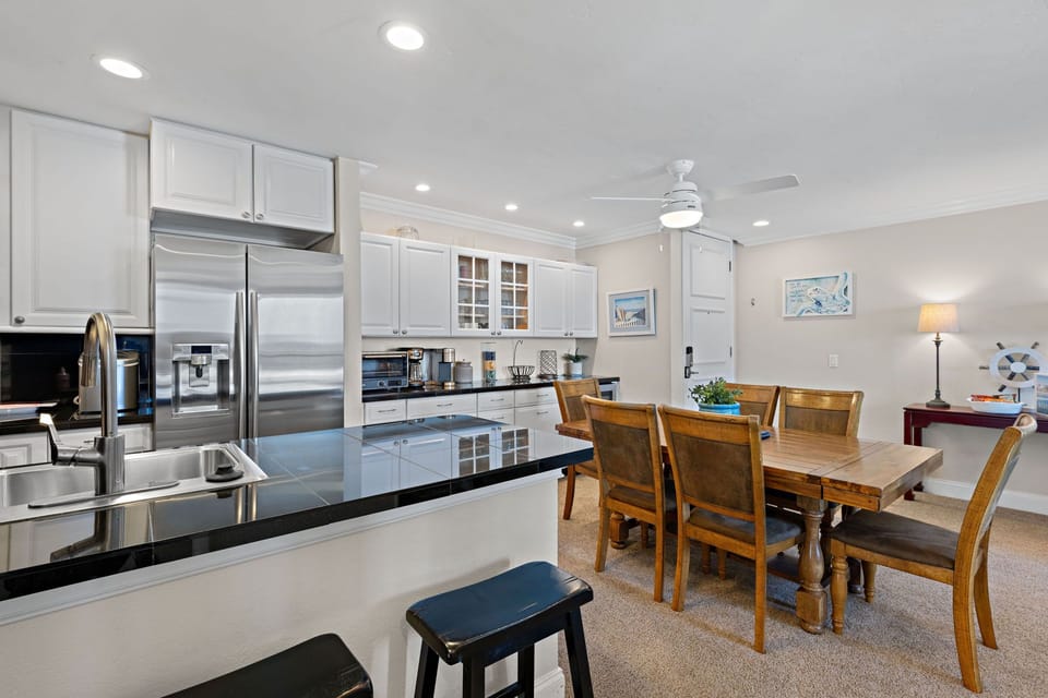 Beautiful wood table seating six with two additional spots at the kitchen counter