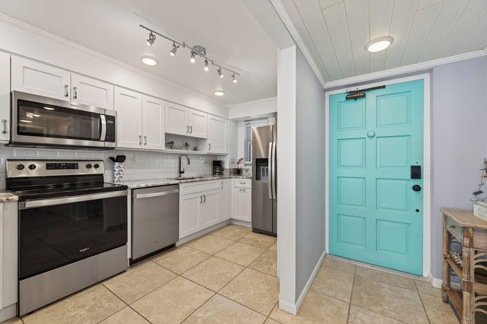 Whip up meals with ease in this bright, beachy kitchen complete with sleek stainless steel appliances!