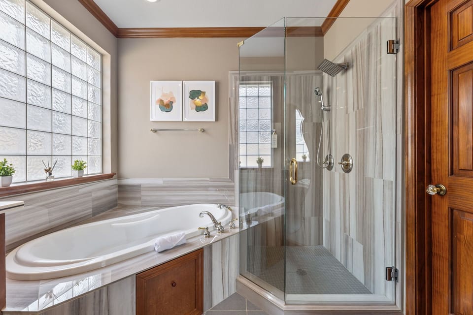 En-Suite Bathroom of the Primary Bedroom with Bathtub, Shower, and Double-Vanity.