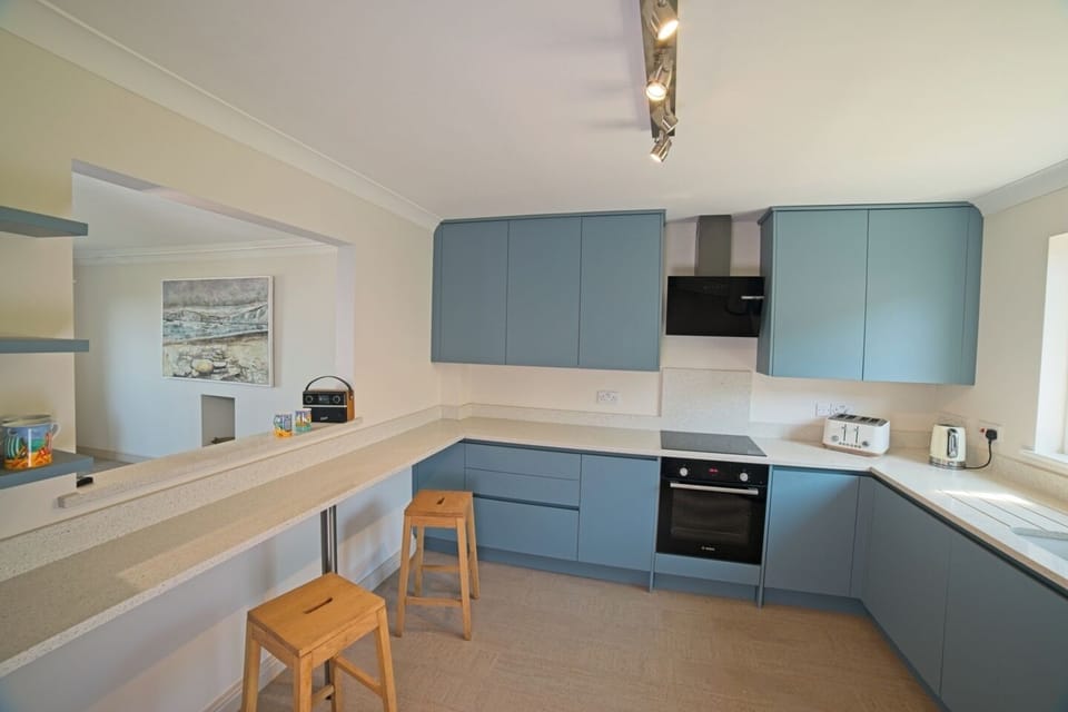 The kitchen space is connected to living and dining space at the breakfast bar