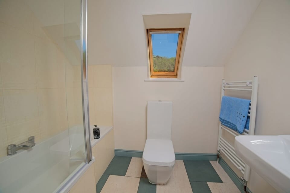 The en-suite bathroom for bedroom 2 has a bath/shower combo