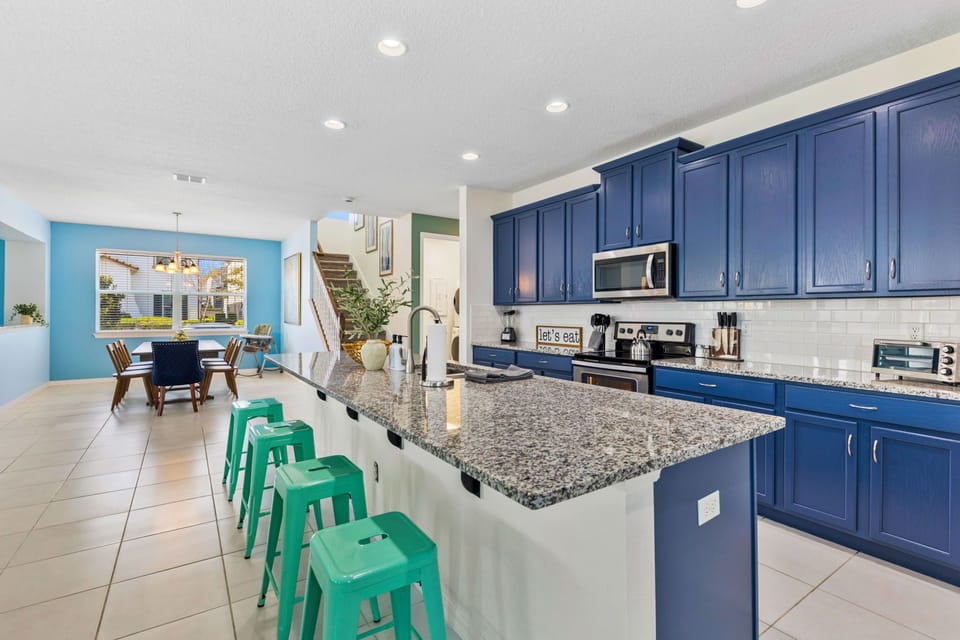 Fully equipped kitchen with barstool seating at the large island counter.