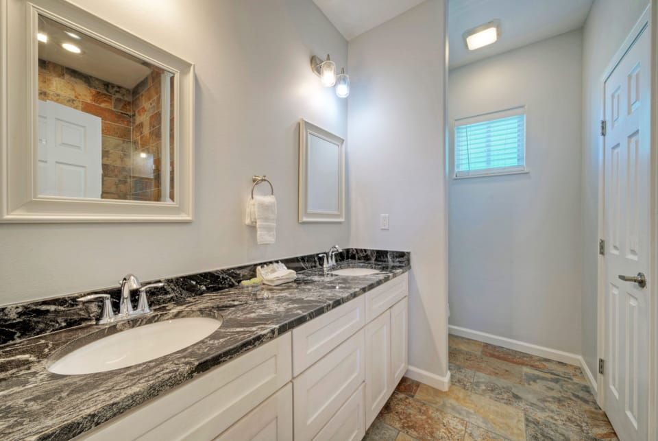 Double vanity sink and large closet in the primary's ensuite. (Keeper Red)
