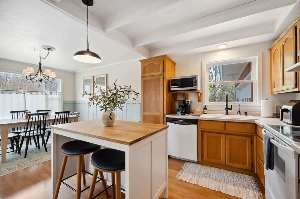 A sunny, fully equipped kitchen, featuring both a standard coffee maker and Keurig, dishwasher, microwave, toaster, and more-perfect for everything from morning pancakes to holiday dinners.