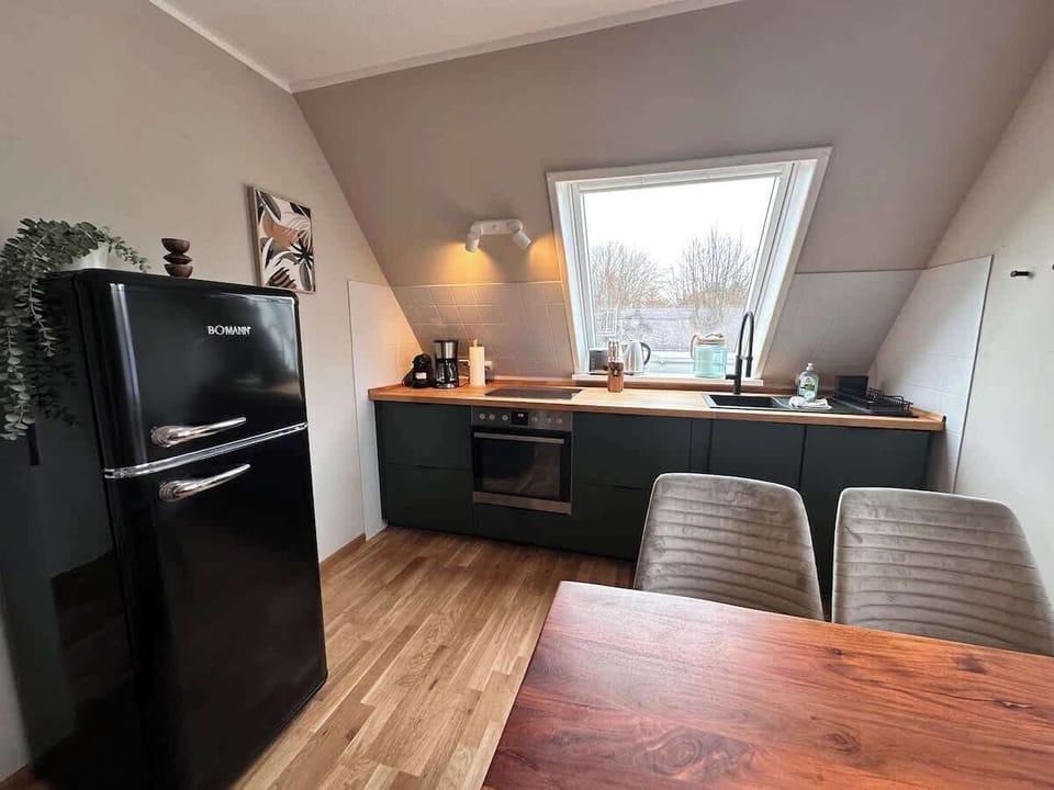 Küche mit Esstisch und freistehendem Retro Kühlschrank. 