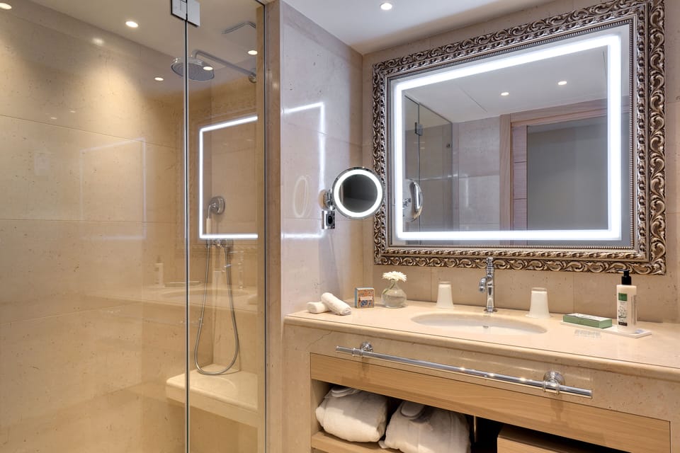 Prestige Deluxe Room, Terrace or garden, spa access | Bathroom | Designer toiletries, hair dryer, bathrobes, slippers