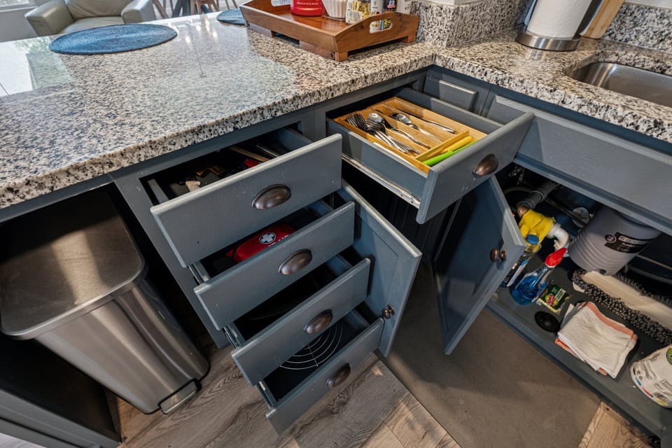 Fully stocked kitchen drawers with utensils, tools, and cleaning supplies—ready for all your cooking and cleanup needs.