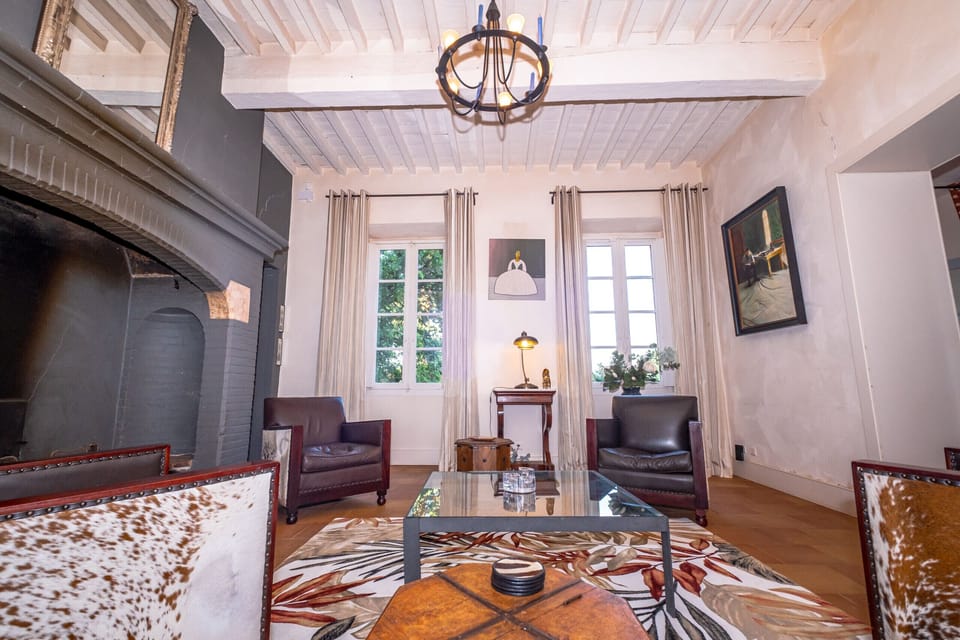 Living room with fireplace, sofa and armchair