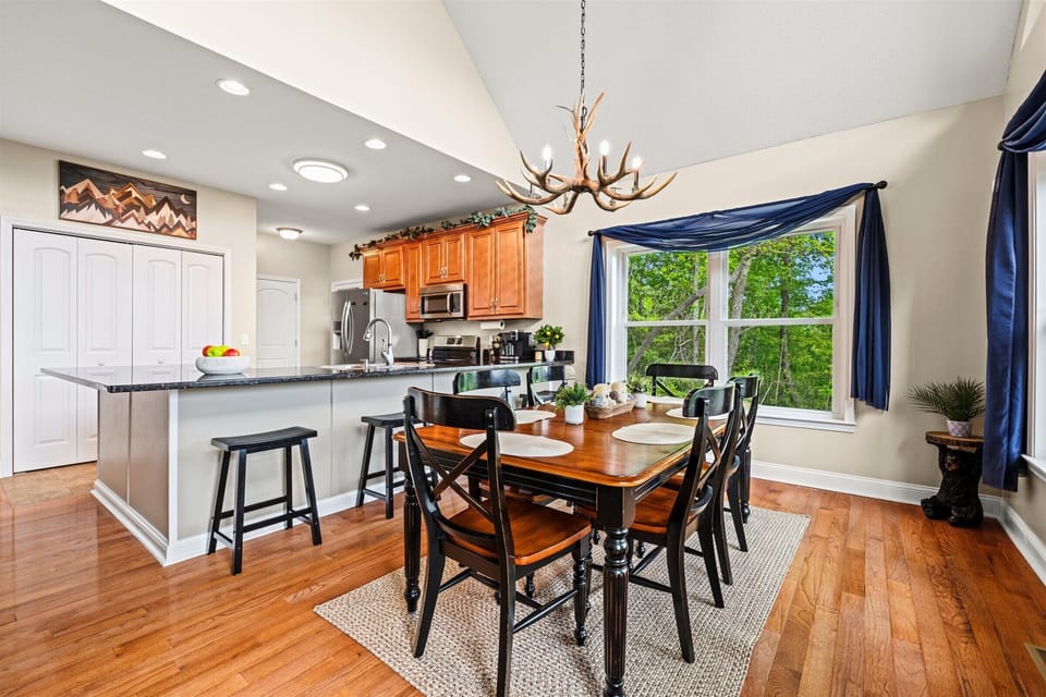 Cook, dine, and unwind in this bright, open kitchen with forest views