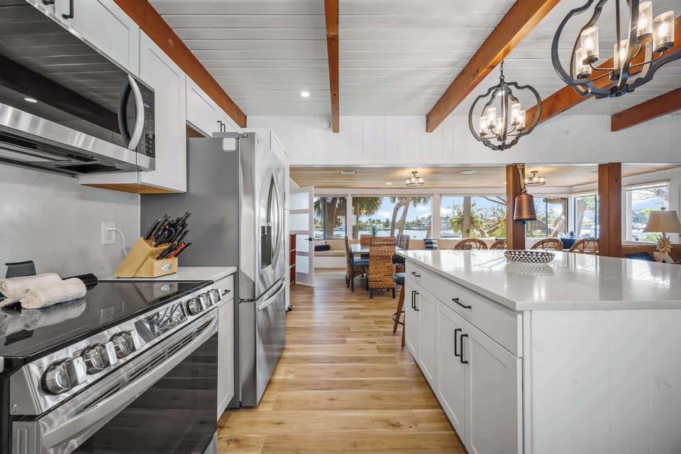Modern kitchen with stainless steel appliances and a view of the waterfront dining area.