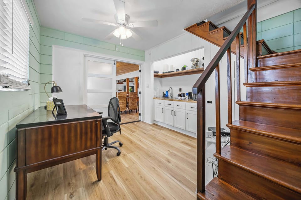 Cozy workspace with natural light and wooden staircase leading upstairs